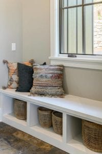 built in bench under window with cubby storage