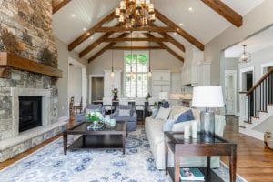 View of living, kitchen, and vaulted ceiling